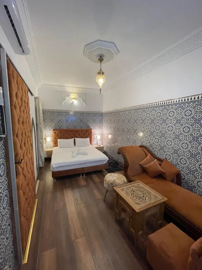 La chambre Deluxe vue en longueur, lit et canapé